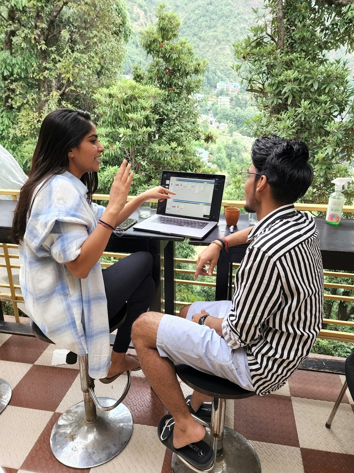 Two people planning together at a table with a laptop