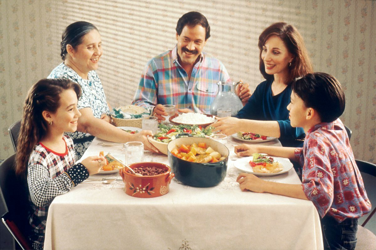 A family eating a meal together at the dining table