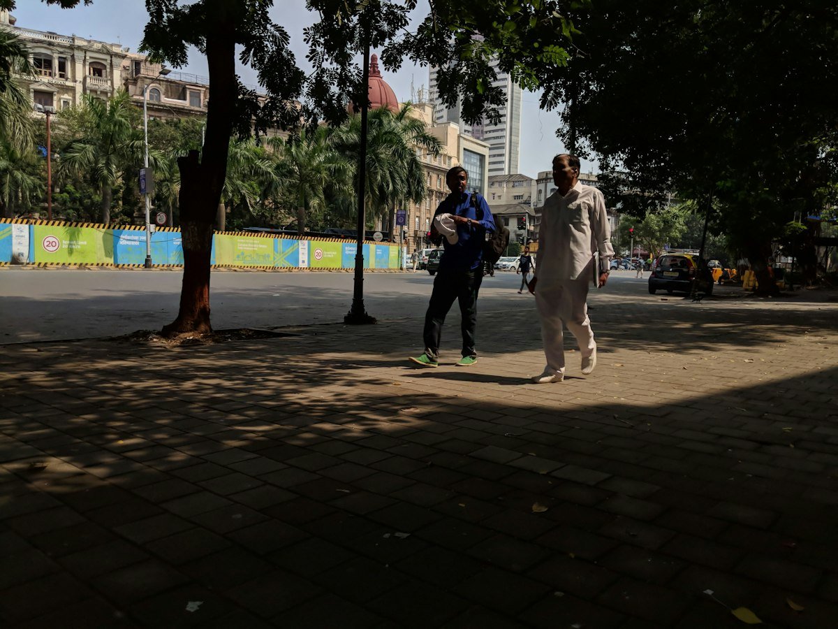 People walking in a city park in the morning